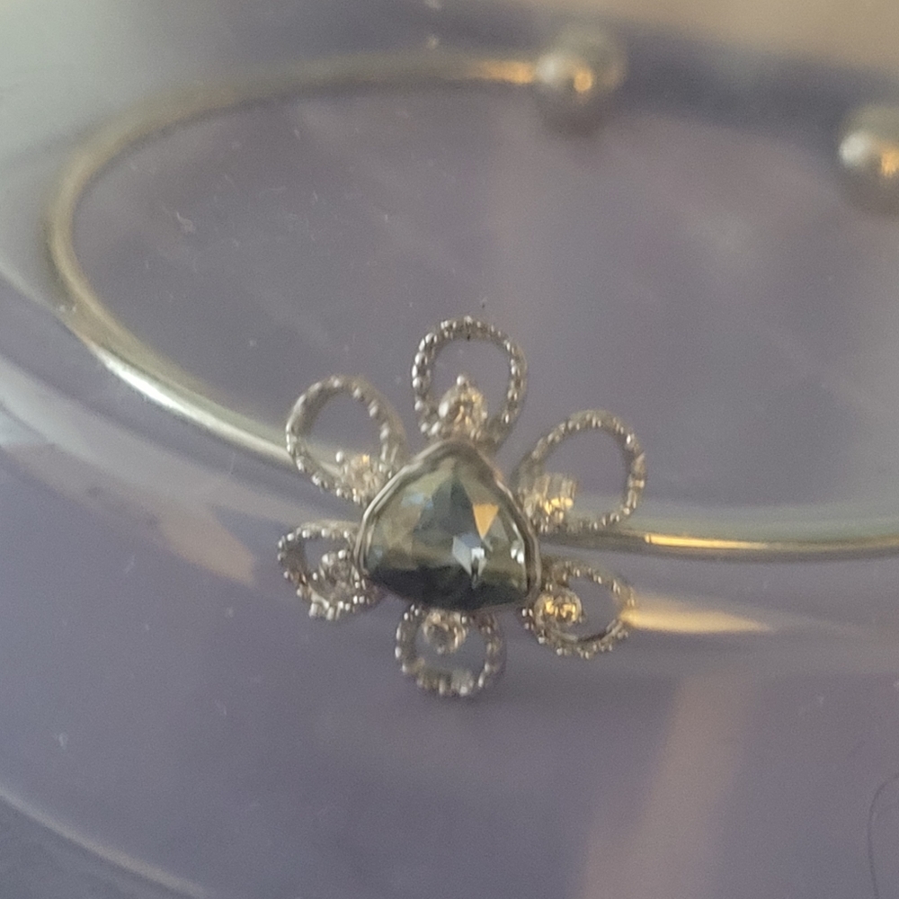 Silver bracelet. With a faux some in the center.